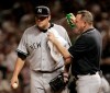 FILE - In this Oct. 5, 2007, file photo, New York Yankees trainer Gene Monahan sprays New York Yankees pitcher Joba Chamberlain with bug spray as small insects swarm in the eighth inning of a baseball playoff game in Cleveland. The 2019 All-Star game is being played in Cleveland on Tuesday, July 8, 2019. (AP Photo/Amy Sancetta, File)