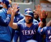 FILE - In this May 29, 2019, file photo, Texas Rangers' Hunter Pence is greeted in the dugout after he scored on an RBI single hit by Asdrubal Cabrera during the first inning of a baseball game in Seattle. Pence was being wished well in retirement last year. Next week, he'll be at the All-Star Game representing the Rangers. (AP Photo/Ted S. Warren, File)