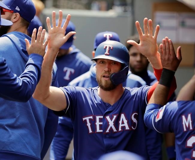 FILE - In this May 29, 2019, file photo, Texas Rangers' Hunter Pence is greeted in the dugout after he scored on an RBI single hit by Asdrubal Cabrera during the first inning of a baseball game in Seattle. Pence was being wished well in retirement last year. Next week, he'll be at the All-Star Game representing the Rangers. (AP Photo/Ted S. Warren, File)