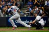 FILE - In this Oct. 20, 2018, file photo, then-Los Angeles Dodgers' Manny Machado (8) hits a single during the fourth inning of Game 7 of the National League Championship Series baseball game against the Milwaukee Brewers, in Milwaukee. A person familiar with the negotiations tells The Associated Press that infielder Manny Machado has agreed to a $300 million, 10-year deal with the rebuilding San Diego Padres, the biggest contract ever for a free agent. The person spoke to the AP on condition of anonymity Tuesday, Feb. 19, 2019, because the agreement was subject to a successful physical and had not been announced.(AP Photo/Jeff Roberson, File)