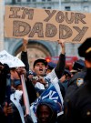 FILE - In this Nov. 6, 2009, file photo, a fan holds a sign referring to Philadelphia Phillies pitcher Pedro Martinez, who was the losing pitcher in Game 6 of the World Series, during a ticker-tape parade along Broadway celebrating the New York Yankees 27th World Series championship, in New York. The Phillies lost to the New York Yankees in six games and Martinez went 0-2 in two starts against the Yankees with a 6.30 ERA _ but has long said he was sick in his Game 6 start at Yankee Stadium and always wished he could have that one back. (AP Photo/Kathy Willens, File)