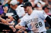 FILE - In this Sept. 30, 2018, file photo, fans congratulate Colorado Rockies third baseman Nolan Arenado after the Rockies defeated the Washington 12-0, in Denver. The sluggish free agent market the last two years has not scared off Colorado third baseman Nolan Arenado, who could be among the prizes in the 2020 pool. (AP Photo/David Zalubowski, File)