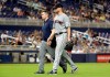FILE - In this May 1, 2019, file photo, Cleveland Indians starting pitcher Corey Kluber, right, leaves during the fifth inning of the team's baseball game against the Miami Marlins, in Miami. Kluber was hit by a single hit by Marlins' Brian Anderson. Kluber is hopeful he‚Äôll be able to come back from a broken right arm and pitch again this season. The two-time Cy Young winner spoke Tuesday, May 7 for the first time since he was struck by a 102 mph line drive last weeki. (AP Photo/Lynne Sladky, File)