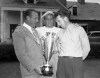 FILE - In this Aug. 21, 1941 file photo, golfer Ray Billows, right, winner of the first Great Lakes amateur golf championship, receives the tournament trophy from Scotty Fessenden, left, president of the Chicago District Golf Association, as Frank Stranahan, center, looks on. Stranahan, a runner-up at two majors as an amateur and a fitness fanatic before it became vogue in golf, died Sunday, June 23, 2013. He was 90. (AP Photo)