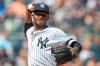 FILE - This is an Aug. 31, 2019, file photo showing New York Yankees pitcher Domingo German throwing to first in a pickoff attempt during the fifth inning of a baseball game against the Oakland Athletics, in New York. Yankees star pitcher Domingo Germán has been placed on administrative leave by Major League Baseball because of domestic violence. MLB did not give details in its statement Thursday, Sept. 19, 2019, but said the leave 