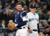 FILE - In this March 29, 2018, file photo, Seattle Mariners catcher Mike Marjama, left, and third baseman Kyle Seager smile after a play by Marjama against the Cleveland Indians during a baseball game in Seattle. Retired catcher Marjama has been suspended for 80 games following a positive steroids test. Major League Baseball said Thursday, May 2, 2019, that Marjama had applied for reinstatement from the voluntary retired list and was suspended for a positive test for the banned performance-enhancing substance Oxandrolone. (AP Photo/Elaine Thompson, File)