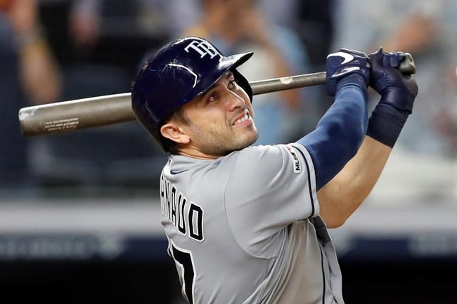 FILE - In this July 15, 2019, file photo, Tampa Bay Rays' Travis d'Arnaud watches his three-run home run during the ninth inning of a baseball game against the New York Yankees, in New York. Travis d'Arnaud is making the most of an opportunity to jumpstart his career with the Tampa Bay Rays, who are getting a lot more production from him than they anticipated when they acquired the 30-year-old catcher for a mere $100,000. (AP Photo/Kathy Willens, File)