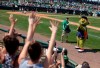 FILE - In this March 17, 2013, file photo, Orbit, the Houston Astros' mascot, fires a T-shirt gun during the sixth inning of the team's spring training baseball game against the Toronto Blue Jays in Kissimmee, Fla. A woman has sued the Astros for more than $1 million, saying that a T-shirt cannon by the team's mascot at a game last season broke her finger. The Houston Chronicle reports that Jennifer Harughty alleges that the mascot, who is named Orbit, 