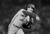 FILE - In this Oct, 22, 1986, file photo, New York Mets' Ron Darling pitches against the Boston Red Sox in the first inning of Game 4 of the World Series at Boston's Fenway Park. Lenny Dykstra has sued former Mets teammate Darling, St. Martin's Press and Macmillan Publishing Group over a passage in the pitcher's new book accusing the outfielder of directing racist comments toward Boston pitcher Oil Can Boyd during the 1986 World Series. (AP Photo/Elise Amendola, File)
