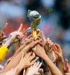 FILE - In this July 7, 2019, file photo, U.S. players hold the trophy as they celebrate their victory in the Women's World Cup soccer final in Decines, outside Lyon, France. FIFA's Council has unanimously approved expanding the Women's World Cup from 24 teams to 32 for 2023 and has reopened bidding to host the tournament but made no mention of changing prize money. FIFA said Wednesday, July 31, 2019, the decision was made remotely. (AP Photo/David Vincent, File)