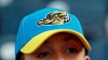 Jake Sheehan, 9, wears an Akron RubberDucks cap as he watches a minor league baseball game between Akron and the Bowie Baysox, Thursday, April 18, 2019, in Akron, Ohio. Up in New England, there are yard goats. In the Deep South, there are spacebound raccoons. A wider scan of the American map reveals a menagerie of unlikely characters, from quarrelsome jumbo shrimp to aggrieved prairie dogs. (AP Photo/Tony Dejak)