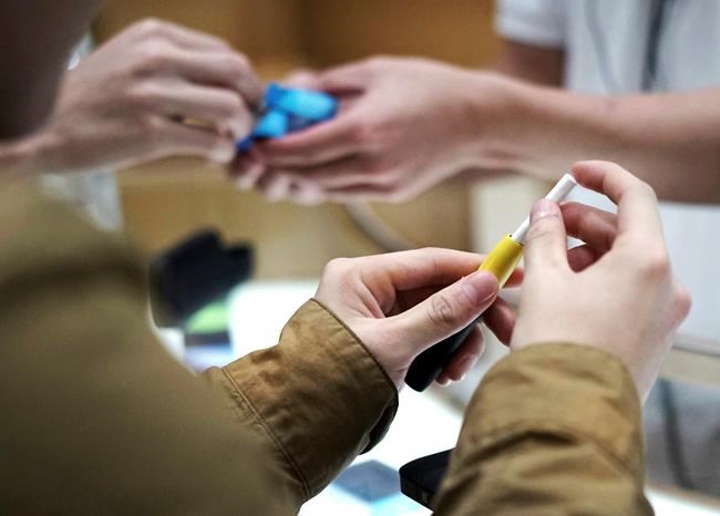 FILE - In this Oct. 22, 2018 file photo, visitors try out a pen-like