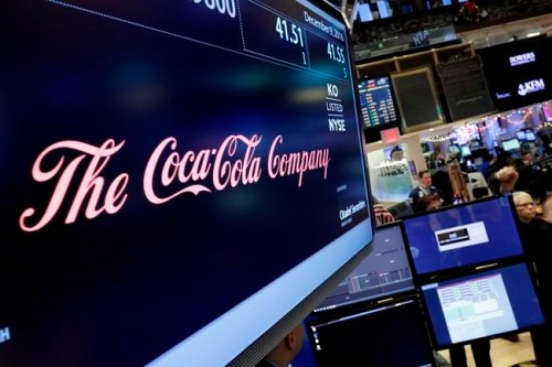 FILE - In this Friday, Dec. 9, 2016 file photo, the Coca-Cola logo appears above the post where it trades on the floor of the New York Stock Exchange. With obesity becoming a more pressing global problem, two January 2109 reports in science journals are calling for policies that limit industry influence and reviving debate about what role food companies should play in public health efforts. (AP Photo/Richard Drew)