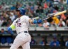 FILE - In this April 4, 2018, file photo, New York Mets' Yoenis Cespedes watches his two-run home run during the first inning of the baseball game against the Philadelphia Phillies at Citi Field in New York. Cespedes says he thinks he will be able to play at some point this season. Recovering from surgery on both heels, the Mets slugger told reporters through a translator at spring training Friday, Feb. 15, 2019, he is finally pain-free. (AP Photo/Seth Wenig, File)
