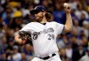 FILE - In this Oct. 19, 2018, file photo, Milwaukee Brewers starting pitcher Wade Miley throws during the first inning of Game 6 of the National League Championship Series baseball game against the Los Angeles Dodgers in Milwaukee. The Houston Astros filled an opening in their rotation, agreeing to a $4.5 million, one-year contract with 32-year-old left-hander Miley. (AP Photo/Matt Slocum, File)