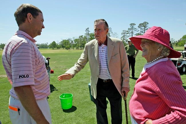 FILE - In this April 3, 2009, file photo, Former President George H.W. Bush, center, and his wife Barbara, right, talk with Davis Love III on the practice range during the first round of the Houston Open golf tournament in Humble, Texas. Love is among several players Bush used to invited to Maine for golf. Bush died Friday, Nov. 30, 2018. (AP Photo/David J. Phillip, File)