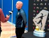 In this photo Sept. 20, 2018, file photo, North Carolina Courage coach Paul Riley is interviewed by a reporter next to the trophy for the National Women's Soccer League championship during a media event at Nike in Beaverton, Ore. The National Women‚Äôs Soccer League opens its seventh season this weekend with lingering some questions about the overall health of the league but the encouraging possibility of a World Cup ‚Äúbump.‚Äù (AP Photo/Anne M. Peterson, File)