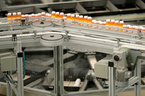 FILE - In this July 10, 2018 file photo, bottles of prescription medicines ride on a conveyor belt at a pharmacy warehouse in Florence, N.J. According to a report released on Tuesday, Jan. 8, 2018, annual spending by the U.S. health industry on ads and promotions has reached $30 billion. That includes advertisements for prescription drugs that were shown 5 million times on TV and elsewhere in 2016. That‚Äôs a huge increase in 20 years and just part of broad health industry efforts to promote drugs, devices, lab tests and even new hospitals. (AP Photo/Julio Cortez, File)