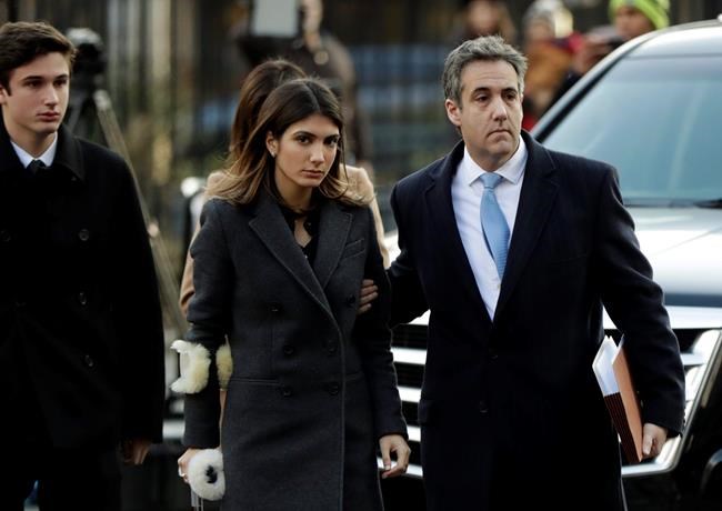 Michael Cohen, right, President Donald Trump's former lawyer, arrives at federal court for his sentencing for dodging taxes, lying to Congress and violating campaign finance laws in New York on Wednesday, Dec. 12, 2018. (AP Photo/Julio Cortez)