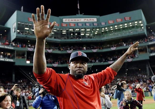 FILE - In this Oct. 10, 2016, file photo, Boston Red Sox's David Ortiz waves from the field at Fenway Park after Game 3 of baseball's American League Division Series against the Cleveland Indians in Boston. Officials say Ortiz, who was shot in the Dominican Republic on June 9, 2019, at an outdoor cafe, was the victim of incompetent criminals who were trying to kill a man next to him. (AP Photo/Charles Krupa, File)