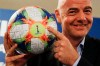 FILE - In this Feb. 27, 2019, file photo, FIFA President Gianni Infantino holds the official ball of the upcoming Women‚Äôs Soccer World Championship as he poses for photographers during a press conference at the end of an executive committee meeting in Rome. FIFA's financial results underscore the glaring disparity between men and women‚Äôs soccer. ‚ÄúWe need to try to find what is the most balanced way and I think we made a step and there will be many more steps going ahead,‚Äù Infantino said in October before his ruling council approved the 2019 Women‚Äôs World Cup prize scale. (AP Photo/Gregorio Borgia, File)