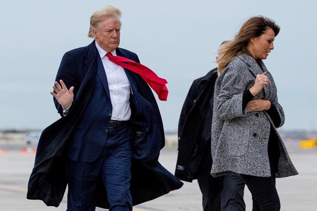 President Donald Trump and first lady Melania Trump walk to board Air Force One on a cold and windy afternoon at John F. Kennedy International Airport in New York, Tuesday, Nov. 12, 2019, to travel to Washington. (AP Photo/Andrew Harnik)