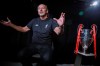 Liverpool soccer chief executive officer Peter Moore gestures during an interview Wednesday, July 24, 2019, in New York At right is the 2019 Champions League championship trophy. (AP Photo/Bebeto Matthews)