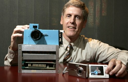File - In this Aug. 17, 2005 file photo, Steven J. Sasson, then Eastman Kodak Co. project manager, shows his prototype digital camera he built in 1975 next to Kodak's latest digital camera the EasyShare One, at Kodak headquarters in Rochester, N.Y. Soon after joining Eastman Kodak Co. Eastman Kodak Co. said Thursday, Feb. 9, 2012, that it will stop making digital cameras, pocket video cameras and digital picture frames, marking the end of an era for the company that brought photography to the masses more than a century ago. (AP Photo/David Duprey, File)
