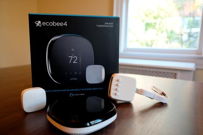 FILE- This Nov. 11, 2018, photo shows an Ecobee smart thermostat, room sensor and connection components in Hastings-on-Hudson, N.Y. Smart thermostats, which let consumers adjust their home temperatures remotely using any internet-connected device, are among the most popular smart home technologies, with the global smart thermostat market surpassing $1 billion in 2017, according to Research and Markets. (AP Photo/Cathy Bussewitz, File)