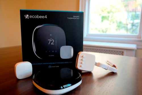 FILE- This Nov. 11, 2018, photo shows an Ecobee smart thermostat, room sensor and connection components in Hastings-on-Hudson, N.Y. Smart thermostats, which let consumers adjust their home temperatures remotely using any internet-connected device, are among the most popular smart home technologies, with the global smart thermostat market surpassing $1 billion in 2017, according to Research and Markets. (AP Photo/Cathy Bussewitz, File)