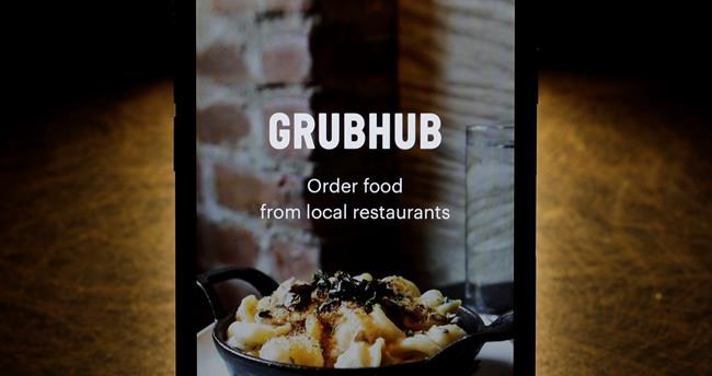 FILE - This Feb. 20, 2018, file photo shows the Grubhub app on an iPhone in Chicago. Shares in GrubHub are down more than 30% before the opening bell on Tuesday, Oct. 29, 2019, after it sharply cut its revenue expectations for the year and warned of intense competition. (AP Photo/Charles Rex Arbogast, File)