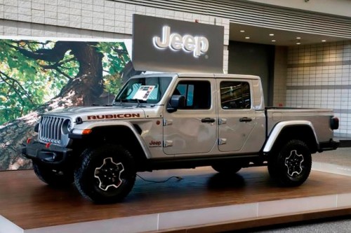 FILE- This Feb. 14, 2019, file photo shows a 2020 Jeep Gladiator on display at the 2019 Pittsburgh International Auto Show in Pittsburgh. The Jeep Gladiator boasts impressive off-road ability, a roomy rear seat and a high maximum towing capacity. (AP Photo/Gene J. Puskar, File)