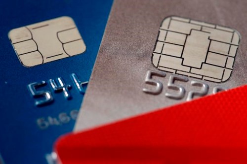 FILE- This June 10, 2015, file photo shows chip credit cards in Philadelphia. Money can‚Äôt buy you a good credit score, but you might be able to use your income tax refund strategically to polish your credit. How to go about it depends on where you are in your credit journey. (AP Photo/Matt Rourke, File)
