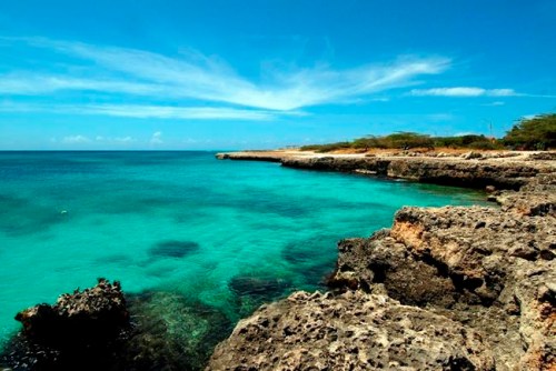 FILE - In this April 2008 file photo, crystal clear water meets the shore in Aruba. Aruba offers a sun-drenched Caribbean escape outside the hurricane belt, making this island retreat an irresistible option for late-summer travelers. (AP Photo/Shoun A. Hill, File)