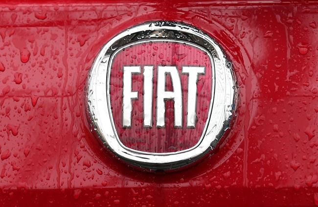 FILE - In this Jan. 2, 2014 file photo, a Fiat logo pictured on a car in Milan, Italy. Fiat Chrysler has agreed to pay $40 million to settle a complaint by securities regulators that it misled investors by overstating monthly sales numbers. (AP Photo/Antonio Calanni, File)