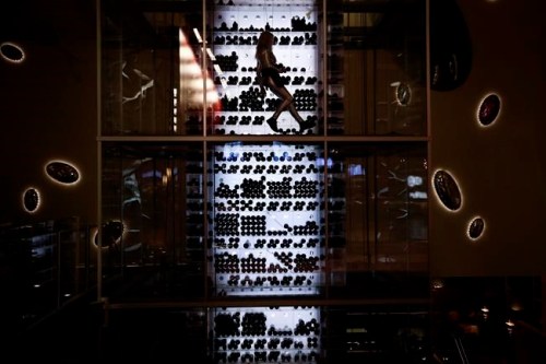 FILE- In this Jan. 7, 2018, file photo Aureole's wine angel rappels up the wind tower at the Mandalay Bay hotel and casino during CES International in Las Vegas. The weeklong event is one of the world‚Äôs largest trade shows and where many tech companies and startups go to show off their latest gadgets and more than 180,000 people are expected to attend CES this year. It is against this background that a growing number of people inside and out of the tech industry are urging organizers of events like CES to ensure that their roster of speakers features a broad array of people, diverse in gender, race as well as in their thinking. (AP Photo/Jae C. Hong, File)