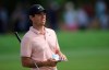 FILE - In this Nov. 17, 2018 file photo, Rory McIlroy, from Northern Ireland, looks at his shot on the 1st hole during the third round of the DP World Tour Championship golf tournament in Dubai, United Arab Emirates. McIlroy has decided to skip the early start of the European Tour season and concentrate on the U.S. tour this year. (AP Photo/Kamran Jebreili, File)