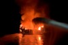 In this photo provided by the Ventura County Fire Department, VCFD firefighters respond to a boat fire off the coast of southern California, Monday, Sept. 2, 2019. The U.S. Coast Guard said it has launched several boats to help over two dozen people 
