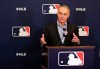 FILE - In this Feb. 8, 2019 file photo, Rob Manfred, commissioner of Major League Baseball, speaks during a news conference at owners meetings in Orlando, Fla. Major League Baseball and Reds are this season commemorating the 150th anniversary of the Cincinnati Red Stockings, who pioneered professional baseball. Manfred will be grand marshal Thursday, March 28 of the 100th Findlay Market Opening Day Parade in Cincinnati. The colorful parade featuring floats, marching bands and celebrities will begin winding through the city. (AP Photo/John Raoux, File)