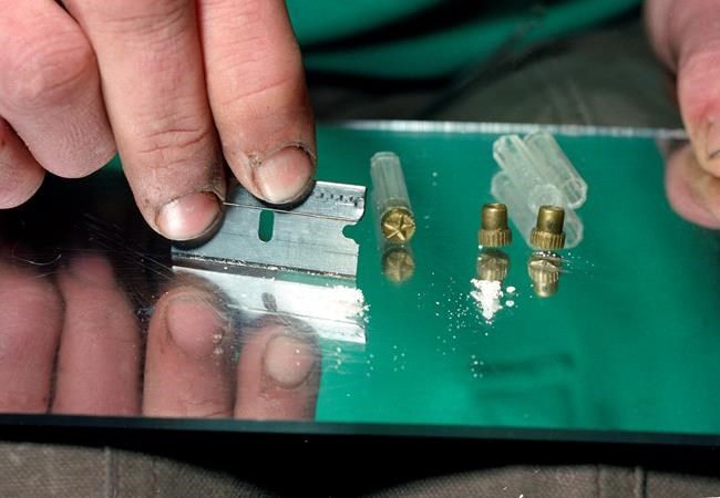 FILE - In this 1989 file photo, a razor blade is used to divide the contents of a five-dollar vile of crack, a smokable, purified form of cocaine, at a crack house in the South Bronx section of New York. Cocaine deaths have been rising, health officials said Thursday, May 2, 2019, in their latest report on the nation’s drug overdose epidemic. After several years of decline, overdose deaths involving cocaine began rising in 2013. And they jumped by more than a third between 2016 and 2017. (AP Photo/Mark Lennihan, File)