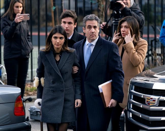 Michael Cohen, right, President Donald Trump's former lawyer, accompanied by his children and wife, arrive at federal court for his sentencing for dodging taxes, lying to Congress and violating campaign finance laws in New York on Wednesday, Dec. 12, 2018. (AP Photo/Craig Ruttle)
