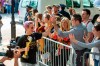 United States women's soccer team member Megan Rapinoe, left, greets fans as she walks to a hotel with the World Cup trophy in her hand Monday, July 8, 2019, in New York. The city will honor the team with a parade on Wednesday. (AP Photo/Corey Sipkin).