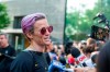 United States women's soccer team member Megan Rapinoe speaks to the media upon her arrival at a hotel Monday, July 8, 2019, in New York. The city will honor the team with a parade Wednesday for their fourth Women's World Cup victory. (AP Photo/Corey Sipkin)