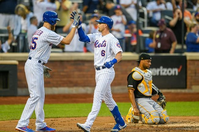 New York Mets Jeff McNeil, center celebrates a three run home run with New York Mets Zack Wheeler as Pittsburgh Pirates catcher Elias Diaz, right looks on during the third inning of a baseball game, Friday, July 26, 2019, in New York. New York Mets Amed Rosario also scored on the play. (AP Photo/Corey Sipkin)