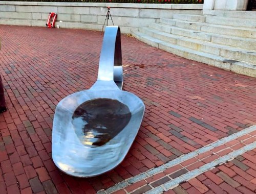 FILE - In this Oct. 26, 2018, file photo, an 11-foot, 800-pound sculpture of a burnt spoon, meant to symbolize opioid use, created by Domenic Esposito, of Westwood, Mass., is briefly displayed in front of the Massachusetts Statehouse in Boston. The Massachusetts-based artist has moved his giant heroin spoon sculpture to a Rhode Island drugmaker's office to protest the opioid overdose crisis. Esposito and a partner placed the sculpture at the front gates of Rhodes Pharmaceuticals in Coventry, R.I., on Thursday, Feb. 7, 2019. (AP Photo/Bob Salsberg, File)