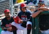 FILE - In this March 18, 2019, file photo, injured Cleveland Indians shortstop Francisco Lindor, center, smiles as he watches his teammates during the first inning of a spring training baseball game against the San Diego Padres in Goodyear, Ariz. Lindor says he‚Äôs ready to make his season debut after being injured. Lindor sat out Cleveland‚Äôs first 18 games with a sprained ankle he sustained during spring training in Arizona while recovering from an offseason calf injury. He‚Äôs expected to be in Cleveland‚Äôs lineup this weekend against Atlanta. (AP Photo/Ross D. Franklin, File)