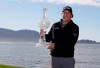 FILE - In this Feb. 11, 2019, file photo, Phil Mickelson poses with his trophy on the 18th green of the Pebble Beach Golf Links after winning the AT&T Pebble Beach Pro-Am golf tournament in Pebble Beach, Calif. At Pebble Beach, a course teeming with history for Mickelson, the 48-year-old, five-time major champion will come face to face with what might be his last, best chance to win the U.S. Open and become the sixth player to complete the career Grand Slam. (AP Photo/Eric Risberg, File)