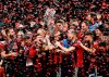 FILE - In this Dec. 8, 2018, file photo, Atlanta United team captain Michael Parkhurst, center, kisses the trophy as teammates celebrate after they defeated the the Portland Timbers 2-0 in the MLS Cup championship soccer game in Atlanta. Atlanta United won 2-0. (AP Photo/Todd Kirkland, File)
