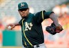 FILE - In this Aug. 11, 2018, file photo, Oakland Athletics starting pitcher Edwin Jackson throws during the first inning of a baseball game against the Los Angeles Angels in Anaheim, Calif. Jackson was acquired by Toronto from Oakland for cash on Saturday, May 11, 2019, and would set a record by pitching for 14 major league teams when he makes his Blue Jays debut. (AP Photo/Mark J. Terrill, File)