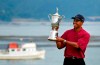 FILE - In this June 18, 2000, file photo Tiger Woods holds the trophy after capturing the 100th U.S. Open Golf Championship at the Pebble Beach Golf Links in Pebble Beach, Calif. For all his feats, however, nothing compares with Woods' 15-shot victory in the 2000 U.S. Open at Pebble Beach, the largest margin in major championship history. (AP Photo/Elise Amendola, File)